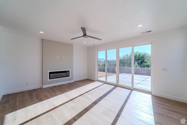 723 S 1220 W Unit 34, Hurricane, UT 84737 - unfurnished living room with light wood-style flooring, visible vents, baseboards, and a glass covered fireplace