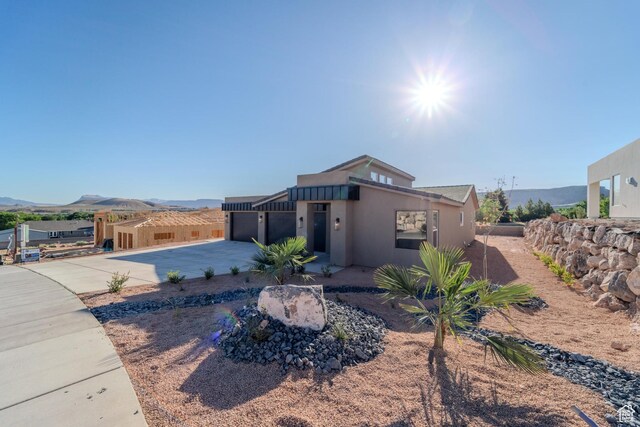 723 S 1220 W Unit 34, Hurricane, UT 84737 - view of front of property featuring an attached garage, a patio area, a mountain view, and concrete driveway