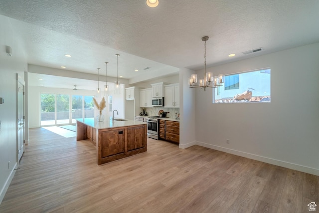 723 S 1220 W Unit 34, Hurricane, UT 84737 - kitchen with light wood-style flooring, white cabinetry, stainless steel appliances, and a sink