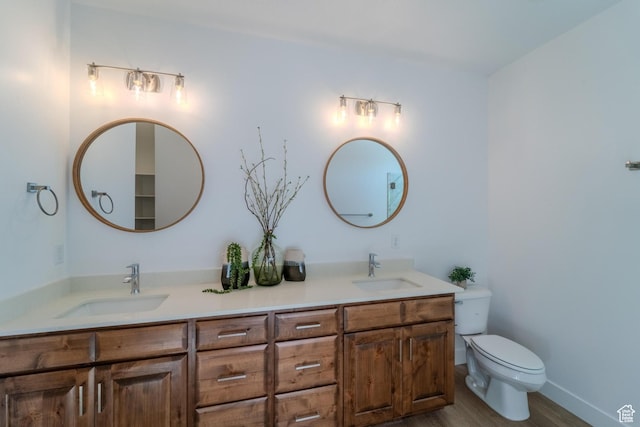 723 S 1220 W Unit 34, Hurricane, UT 84737 - bathroom featuring toilet, double vanity, a sink, and wood finished floors