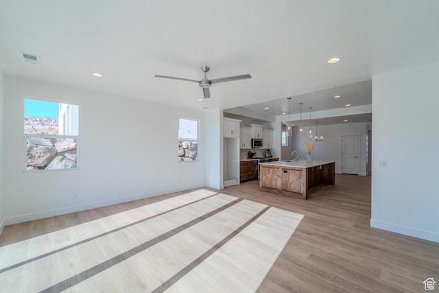 723 S 1220 W Unit 34, Hurricane, UT 84737 - unfurnished living room with baseboards, visible vents, light wood-style flooring, a sink, and recessed lighting