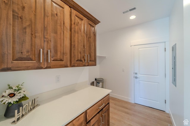 723 S 1220 W Unit 34, Hurricane, UT 84737 - kitchen featuring visible vents, baseboards, light countertops, brown cabinets, and light wood finished floors