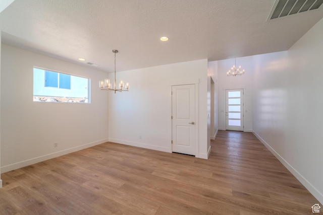 723 S 1220 W Unit 34, Hurricane, UT 84737 - spare room featuring light wood-type flooring, an inviting chandelier, and visible vents