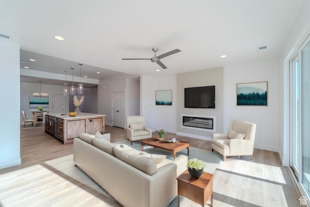 723 S 1220 W Unit 34, Hurricane, UT 84737 - living room featuring a glass covered fireplace, visible vents, light wood-style flooring, and recessed lighting