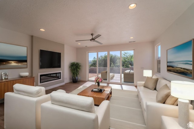 723 S 1220 W Unit 34, Hurricane, UT 84737 - living area featuring recessed lighting, wood finished floors, a textured ceiling, and a glass covered fireplace