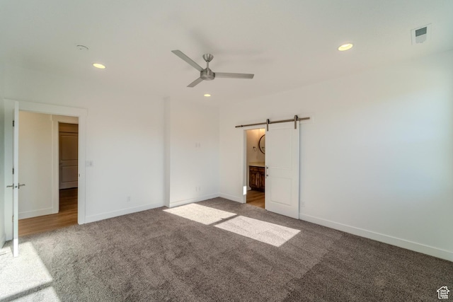 723 S 1220 W Unit 34, Hurricane, UT 84737 - unfurnished bedroom featuring a barn door, visible vents, carpet flooring, and recessed lighting