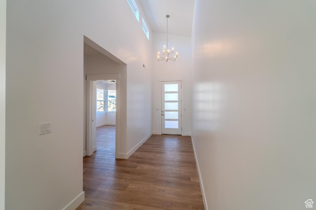 723 S 1220 W Unit 34, Hurricane, UT 84737 - hallway with baseboards, wood finished floors, a towering ceiling, and a notable chandelier