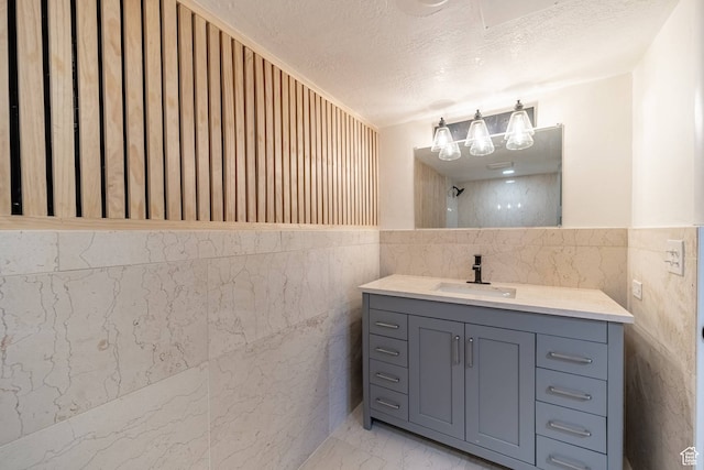 875 S Donner Way Unit 1203, Salt Lake City, UT 84108 - bathroom featuring vanity, tile walls, and a textured ceiling