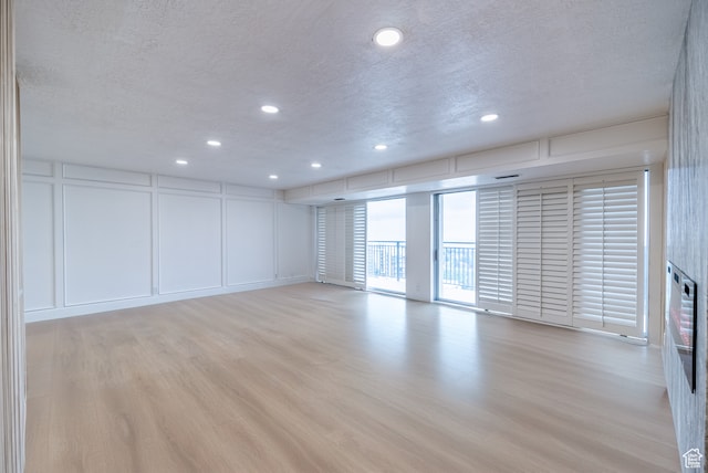 875 S Donner Way Unit 1203, Salt Lake City, UT 84108 - unfurnished room featuring light hardwood / wood-style floors and a textured ceiling
