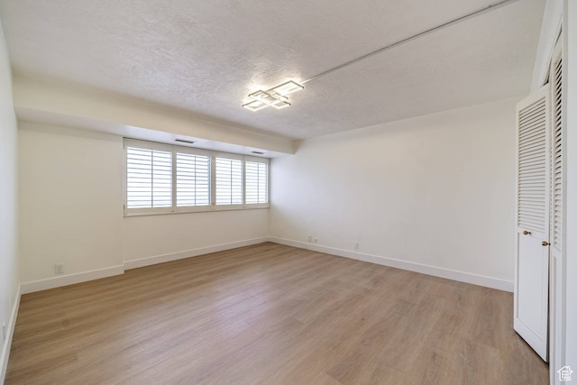 875 S Donner Way Unit 1203, Salt Lake City, UT 84108 - spare room featuring a textured ceiling and hardwood / wood-style floors
