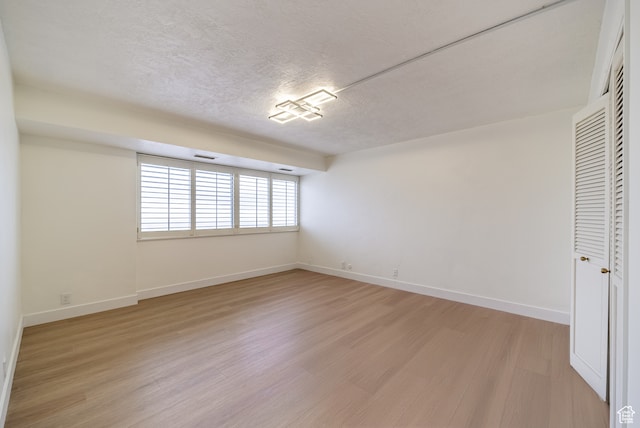875 S Donner Way Unit 1203, Salt Lake City, UT 84108 - empty room with hardwood / wood-style floors and a textured ceiling