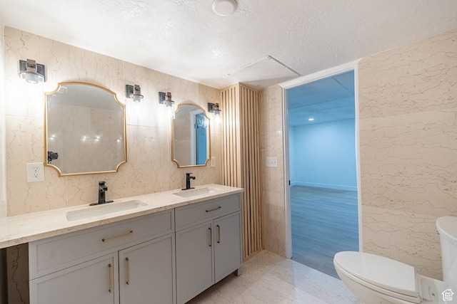 875 S Donner Way Unit 1203, Salt Lake City, UT 84108 - bathroom featuring double sink vanity, toilet, tile floors, and a textured ceiling