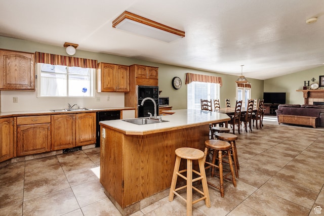 1560 E 1580 N, Logan, UT 84341 - kitchen featuring light tile flooring, black appliances, sink, and an island with sink