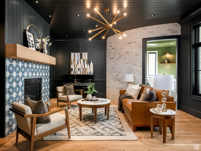 616 E Stokes Ave S, Draper, UT 84020 - living room featuring light hardwood / wood-style flooring, an inviting chandelier, and brick wall