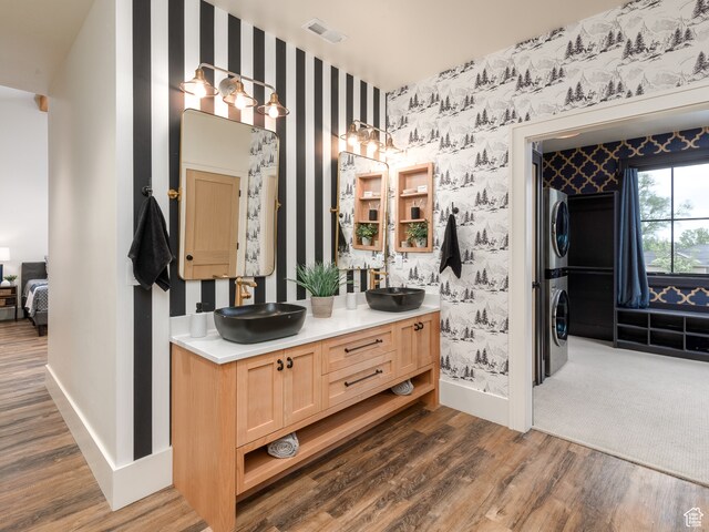 616 E Stokes Ave S, Draper, UT 84020 - bathroom featuring vanity with extensive cabinet space, double sink, hardwood / wood-style floors, and stacked washer / drying machine