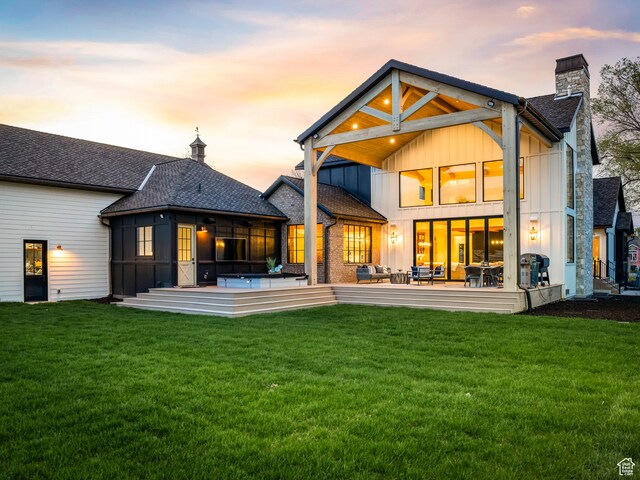 616 E Stokes Ave S, Draper, UT 84020 - back house at dusk with a patio, a balcony, a yard, and a sunroom