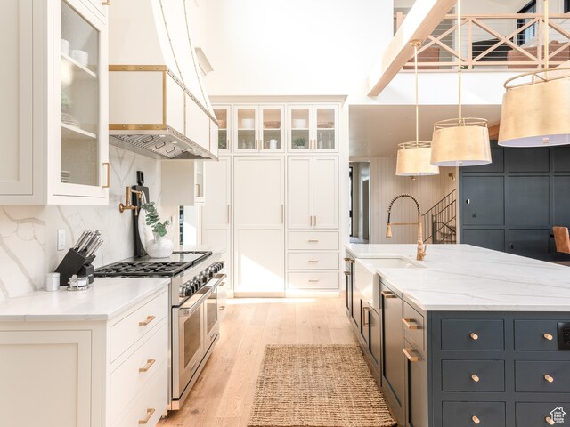 616 E Stokes Ave S, Draper, UT 84020 - kitchen featuring double oven range, pendant lighting, white cabinetry, and light wood-type flooring