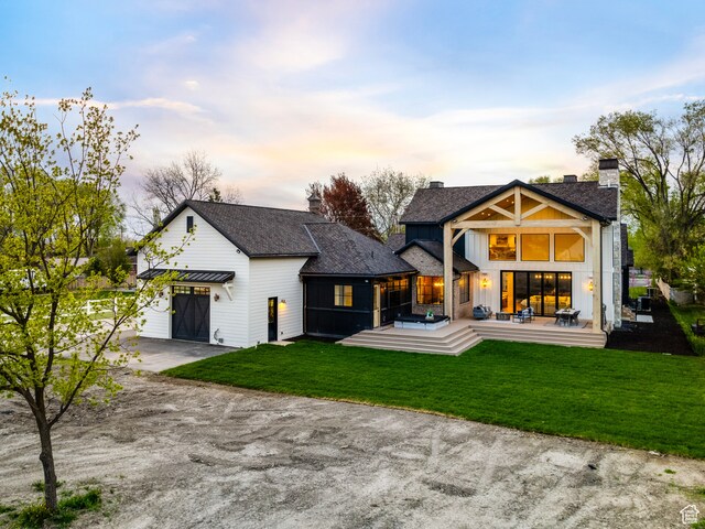 616 E Stokes Ave S, Draper, UT 84020 - back house at dusk with a patio area and a yard