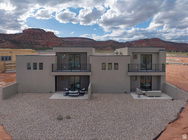 400 S Moki Dr Unit I-1, Kanab, UT 84741 - back of house featuring a balcony, an outdoor living space, stucco siding, and a patio