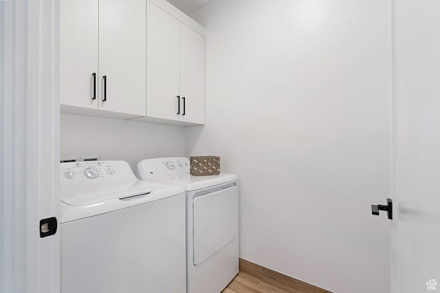 400 S Moki Dr Unit I-1, Kanab, UT 84741 - laundry room with washing machine and dryer, cabinet space, and light wood finished floors