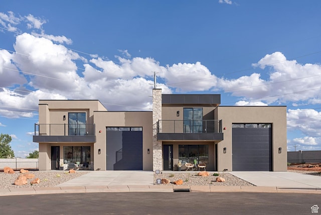 400 S Moki Dr Unit I-1, Kanab, UT 84741 - modern home featuring a balcony, stucco siding, concrete driveway, and a garage