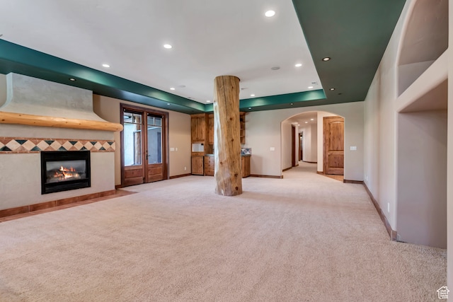 4345 W Stoneybrook Cir, Alpine, UT 84004 - unfurnished living room featuring french doors, a tiled fireplace, carpet, and a tray ceiling