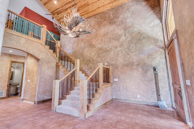 4345 W Stoneybrook Cir, Alpine, UT 84004 - staircase featuring high vaulted ceiling, wooden ceiling, tile floors, and an inviting chandelier
