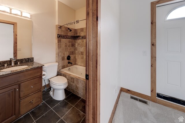 1145 E Bonita St, Moab, UT 84532 - full bathroom featuring tile floors, vanity, tiled shower / bath combo, and toilet