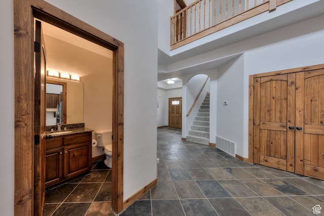 1145 E Bonita St, Moab, UT 84532 - foyer entrance with sink, dark tile flooring, and a high ceiling