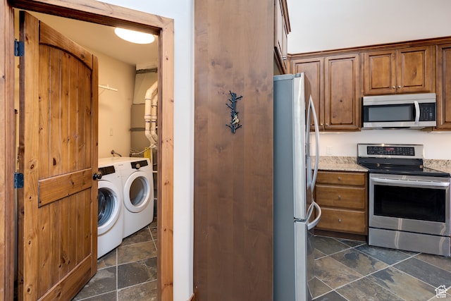 1145 E Bonita St, Moab, UT 84532 - kitchen with stainless steel appliances, washer and dryer, and dark tile floors