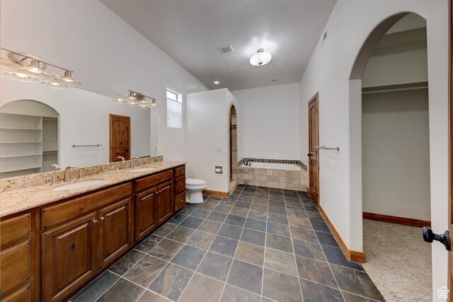 1145 E Bonita St, Moab, UT 84532 - bathroom with double sink, a bathing tub, oversized vanity, tile flooring, and toilet