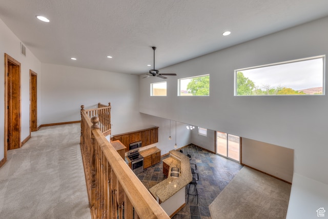 1145 E Bonita St, Moab, UT 84532 - interior space with a textured ceiling, ceiling fan, and carpet floors