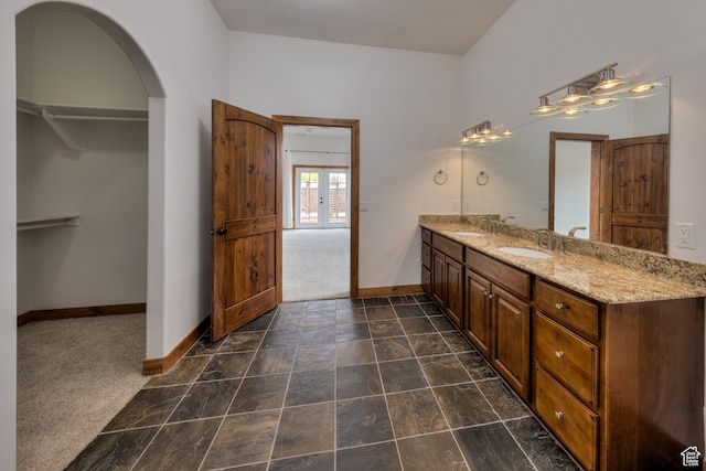 1145 E Bonita St, Moab, UT 84532 - bathroom with french doors, tile floors, and double sink vanity