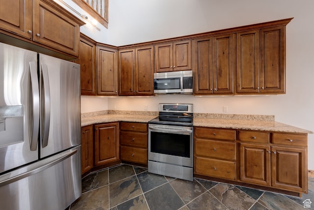 1145 E Bonita St, Moab, UT 84532 - kitchen with light stone counters, dark tile floors, and stainless steel appliances
