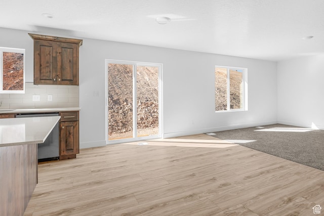 1698 S Marigold Unit 242, Santaquin, UT 84655 - unfurnished living room with plenty of natural light, baseboards, and light wood-style floors