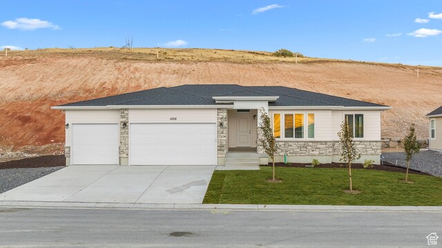 1698 S Marigold Unit 242, Santaquin, UT 84655 - view of front of home with stone siding, an attached garage, a front lawn, and concrete driveway