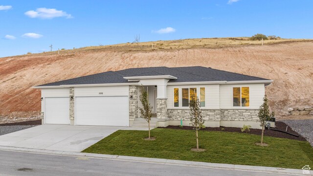 1698 S Marigold Unit 242, Santaquin, UT 84655 - view of front of home with stone siding, an attached garage, concrete driveway, and a front lawn