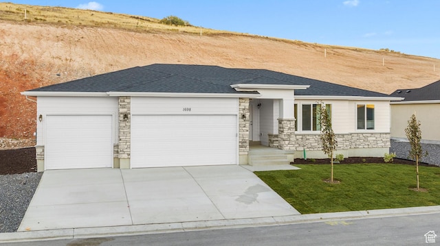1698 S Marigold Unit 242, Santaquin, UT 84655 - view of front of house featuring stone siding, a garage, concrete driveway, and a front lawn