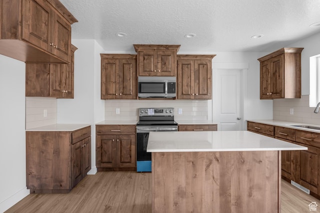 1698 S Marigold Unit 242, Santaquin, UT 84655 - kitchen with stainless steel appliances, light wood-style flooring, decorative backsplash, a sink, and recessed lighting