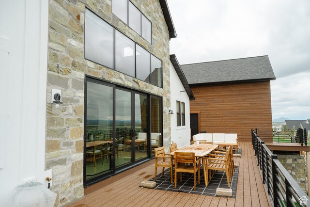 wooden deck featuring outdoor dining space