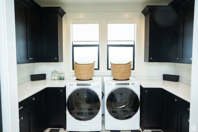 washroom with cabinet space and washing machine and dryer