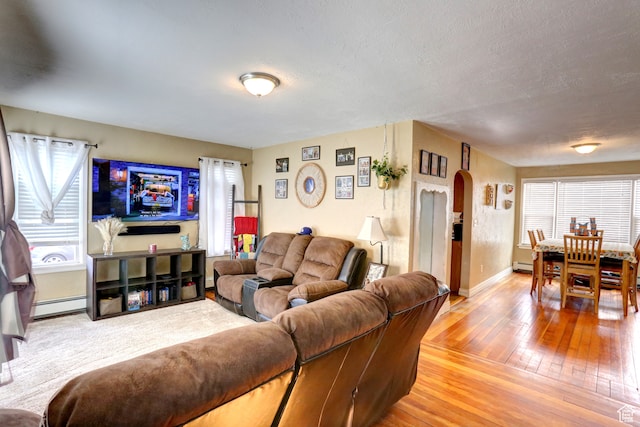 390 N 100 E, Spanish Fork, UT 84660 - living room featuring baseboard heating, a textured ceiling, and light wood-type flooring
