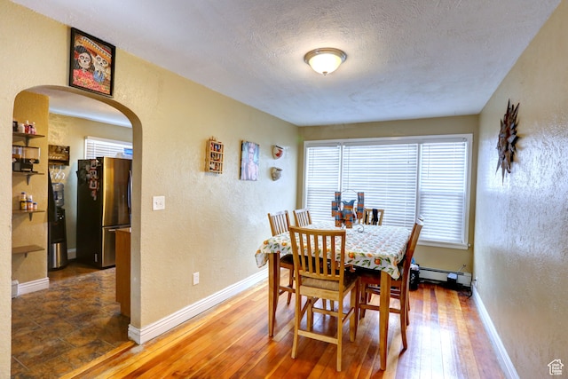 390 N 100 E, Spanish Fork, UT 84660 - dining room featuring baseboard heating, a textured ceiling, and hardwood / wood-style floors