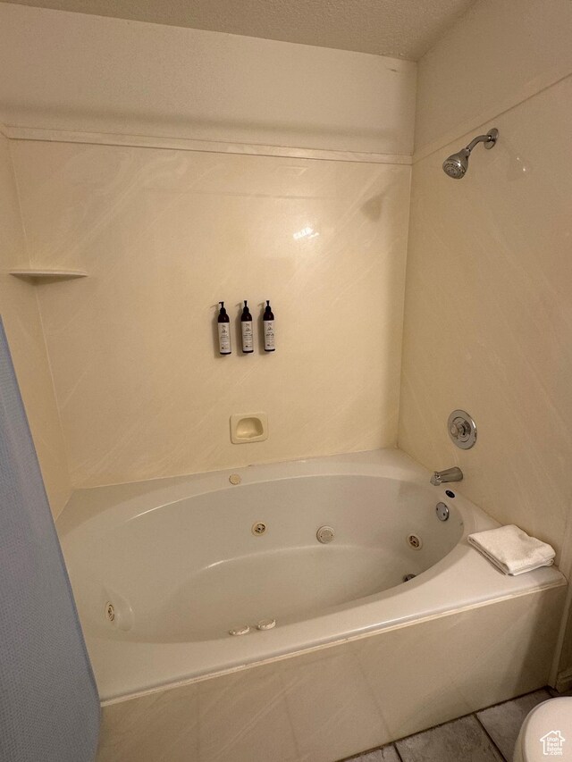 888 N Newburg Dr Unit 1, Garden City, UT 84028 - full bathroom with a combined bath / shower with jetted tub, tile patterned floors, and toilet
