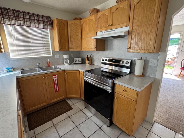888 N Newburg Dr Unit 1, Garden City, UT 84028 - kitchen featuring stainless steel electric range oven, under cabinet range hood, a sink, light countertops, and a textured ceiling