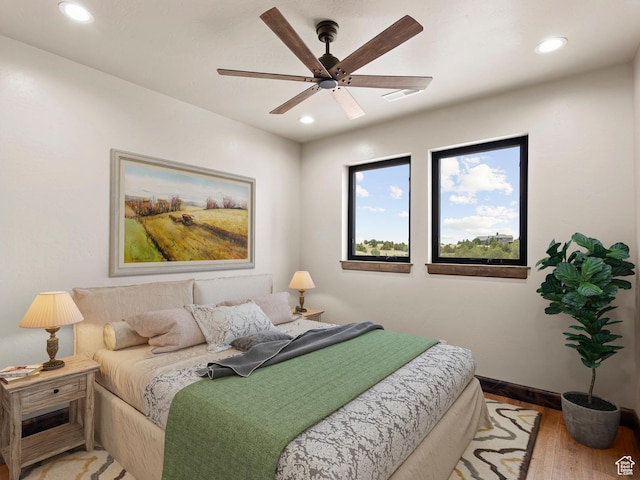 bedroom featuring a ceiling fan, baseboards, light wood-style floors, and recessed lighting