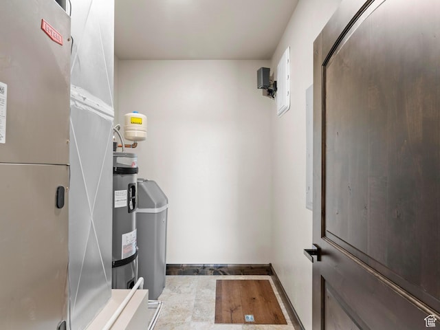 utility room with electric water heater
