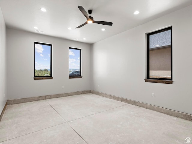 unfurnished room with baseboards, concrete flooring, recessed lighting, and a ceiling fan