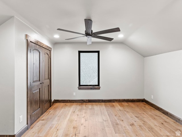 additional living space with vaulted ceiling, light wood-type flooring, baseboards, ceiling fan, and recessed lighting
