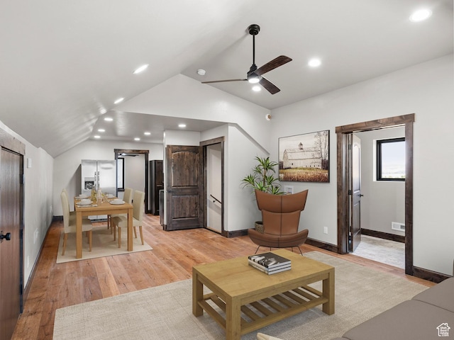 living area featuring vaulted ceiling, recessed lighting, ceiling fan, light wood-style flooring, and visible vents